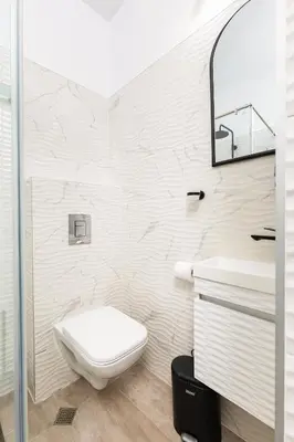 a white bathroom with a toilet and a sink at Cozy Floor from a House Near the City Center by Flat Mаnager in Plovdiv