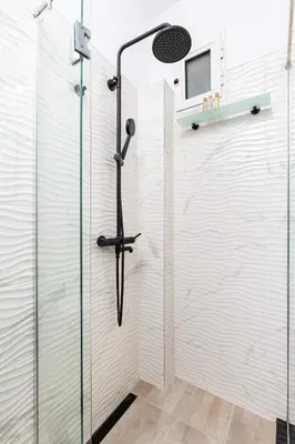 a shower in a bathroom with a glass door at Cozy Floor from a House Near the City Center by Flat Mаnager in Plovdiv
