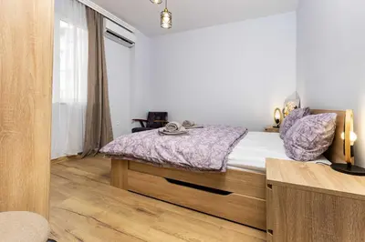 a bedroom with a bed and a window at Cozy Floor from a House Near the City Center by Flat Mаnager in Plovdiv