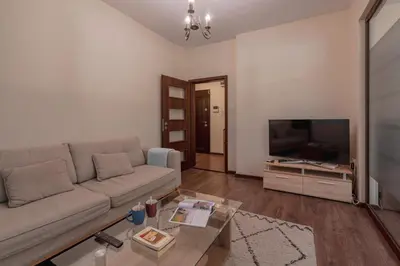a living room with a couch and a flat screen tv at Nice 1 BDR apartment next to National Palace of Culture in Sofia
