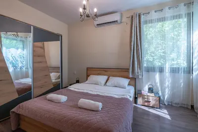 a bedroom with a bed with two pillows on it at Nice 1 BDR apartment next to National Palace of Culture in Sofia