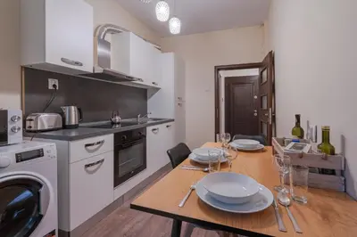 a kitchen with a table with plates on it at Nice 1 BDR apartment next to National Palace of Culture in Sofia