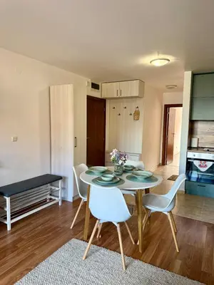 a kitchen and dining room with a table and chairs at Pirin Sense Apartment Home2Host in Bansko