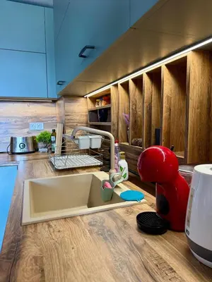 a kitchen counter with a sink and a red mixer at Pirin Sense Apartment Home2Host in Bansko