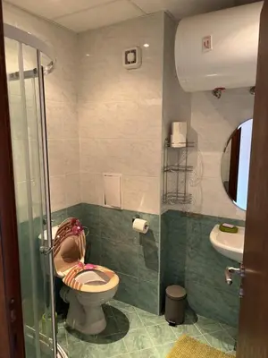 a bathroom with a toilet and a sink at Pirin Sense Apartment Home2Host in Bansko