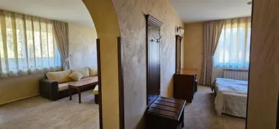 a room with a bed and a couch in a room at Свети Георги хотел и ресторант in Govedartsi