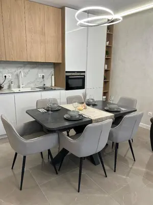 a kitchen with a dining room table and chairs at Le bijou Lauta Forest in Plovdiv