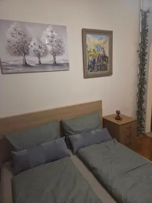 a bedroom with two beds and a painting on the wall at Smart Budget Stay at Sofia Centre by NDK and Vitosha Blvd in Sofia