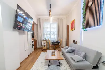 a living room with a couch and a table at Two Vintage Apartments by NDK and Vitosha Blvd with Free Parking in Sofia