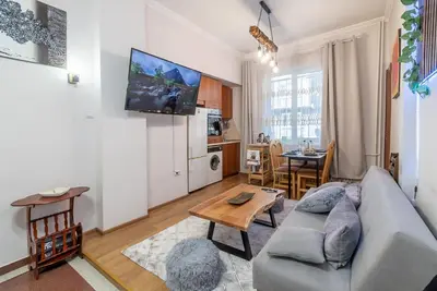 a living room with a couch and a table at Three Vintage Apartments by NDK and Vitosha Blvd with Free Parking in Sofia