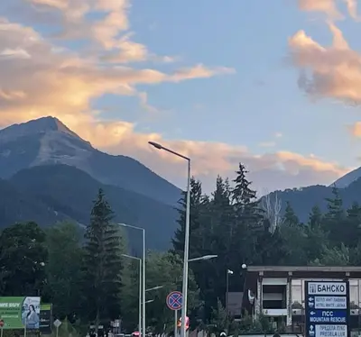 a street light on a road with mountains in the background at The View Bansko in Bansko