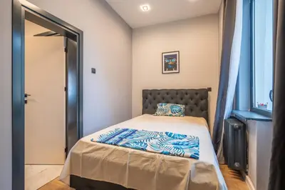 a small bedroom with a bed and a window at Stylish 2BDRM Apartment in the Very Heart of Sofia in Sofia