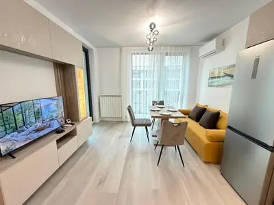 a living room with a yellow couch and a table at Cusco Cozy Apt w Parking Spot near Paradise Mall and WiFI in Sofia