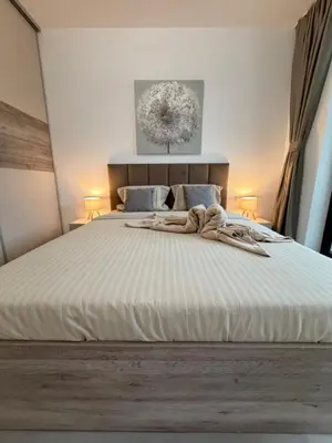 a bedroom with a large white bed with two lamps at Cusco Cozy Apt w Parking Spot near Paradise Mall and WiFI in Sofia