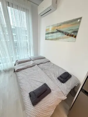 a bed in a room with two towels on it at Cusco Cozy Apt w Parking Spot near Paradise Mall and WiFI in Sofia