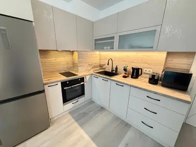 a kitchen with white cabinets and a sink at Cusco Cozy Apt w Parking Spot near Paradise Mall and WiFI in Sofia