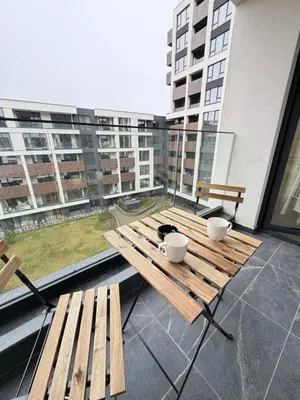 a wooden table with two cups on a balcony at Cusco Cozy Apt w Parking Spot near Paradise Mall and WiFI in Sofia