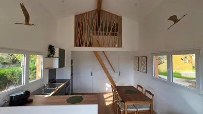 a kitchen and dining room with a wooden table in a house at Cottage for 4 people 30 in Sofia
