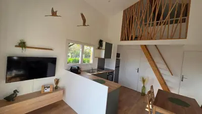 a living room with a large television and a kitchen at Cottage for 4 people 30 in Sofia