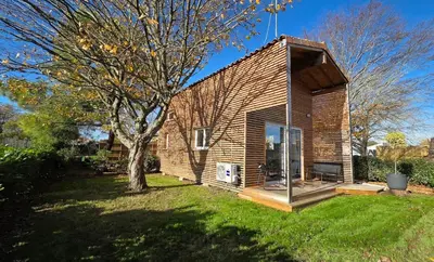 a small house with a tree in a yard at Cottage for 4 people 30 in Sofia