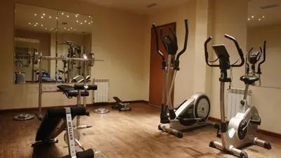 a gym with several exercise equipment in a room at Your studio at Winslow Infinity in Bansko