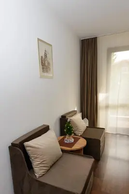 a living room with two couches and a table at Your studio at Winslow Infinity in Bansko