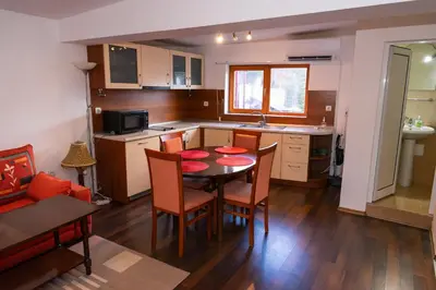 a kitchen and dining room with a table and chairs at Къща за гости Рилски рай in Samokov