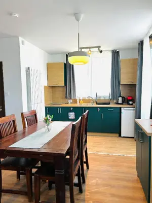 a kitchen and dining room with a table and chairs at Къща за гости Касида in Sapareva Banya