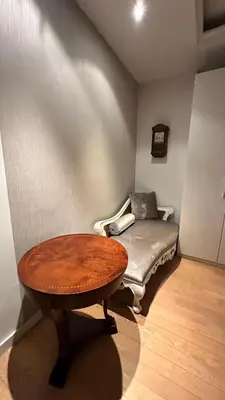 a table and a couch in a room with a bench at Bonnie's Stylsih 2BR Home near the Palace in Sofia