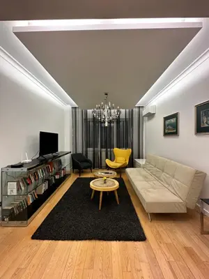 a living room with a couch and a table at Bonnie's Stylsih 2BR Home near the Palace in Sofia