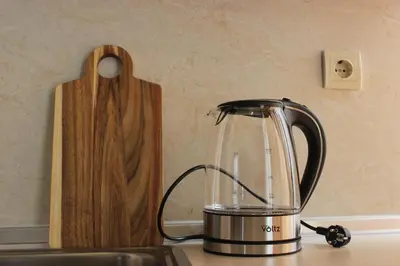 a tea kettle sitting on top of a kitchen counter at morning in the mountains - apartment in Razlog