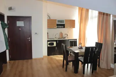 a kitchen and dining room with a table and chairs at morning in the mountains - apartment in Razlog