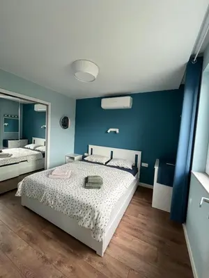 a bedroom with a bed and a blue wall at Green view 180 in Troyan
