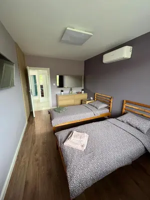 a bedroom with two beds and a sink at Green view 180 in Troyan