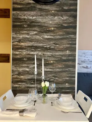 a dining table with white plates and candles on it at Flower home 1 in Sofia