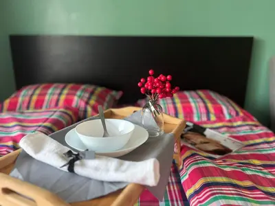 two beds with a tray with a bowl and a bowl at Flower home 2 in Sofia