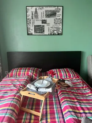 a table on a bed with a plate on it at Flower home 2 in Sofia