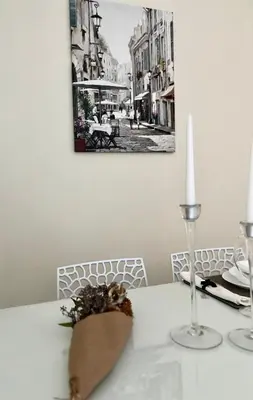 a white table with a candle on top of it at Flower home 4 in Sofia