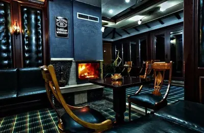 a restaurant with a fireplace and a table and chairs at Deluxe Apartment in Bansko
