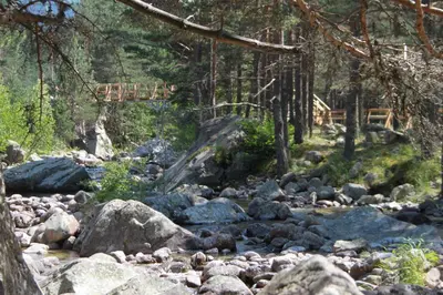 a stream of rocks with a bridge in the background at The Stone Villa in Beli Iskar