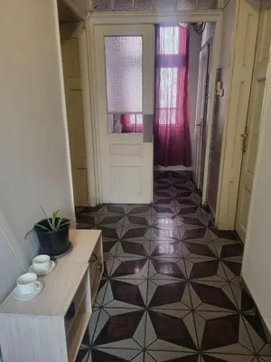 a hallway with a room with a tiled floor at Hostel Alex 1 in Sofia