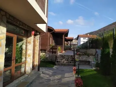 a house with a walkway next to a building at Andreevite Houses in Sapareva Banya