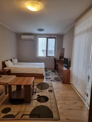 a small room with a bed and a table and a couch at Andreevite Houses in Sapareva Banya