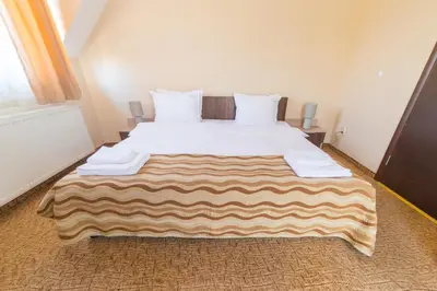 a bedroom with a large white bed in a room at Ring Hotel in Blagoevgrad