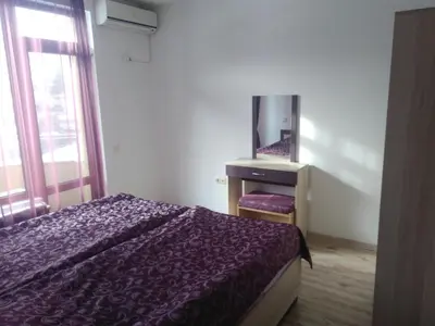 a bedroom with a bed and a dresser with a mirror at Family Hotel Relaxa in Sapareva Banya