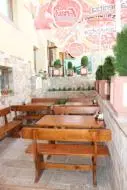 a row of wooden benches in a restaurant at Family Hotel Relaxa in Sapareva Banya