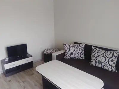 a living room with a couch and a tv at Family Hotel Relaxa in Sapareva Banya