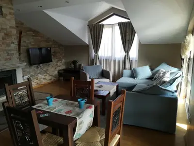 a living room with a couch and a table at Apartments Elegance in Bansko