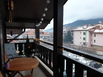 a balcony with a table and a view of a city at Apartments Elegance in Bansko