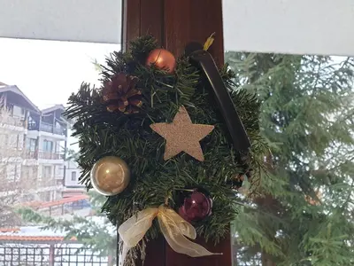 a christmas wreath with a star on a pole at Apartments Elegance in Bansko